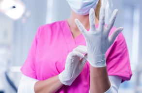 dentist-in-pink-scrubs-putting-on-surgical-gloves-2023-11-27-04-55-16-utc-scaled-1 (1)